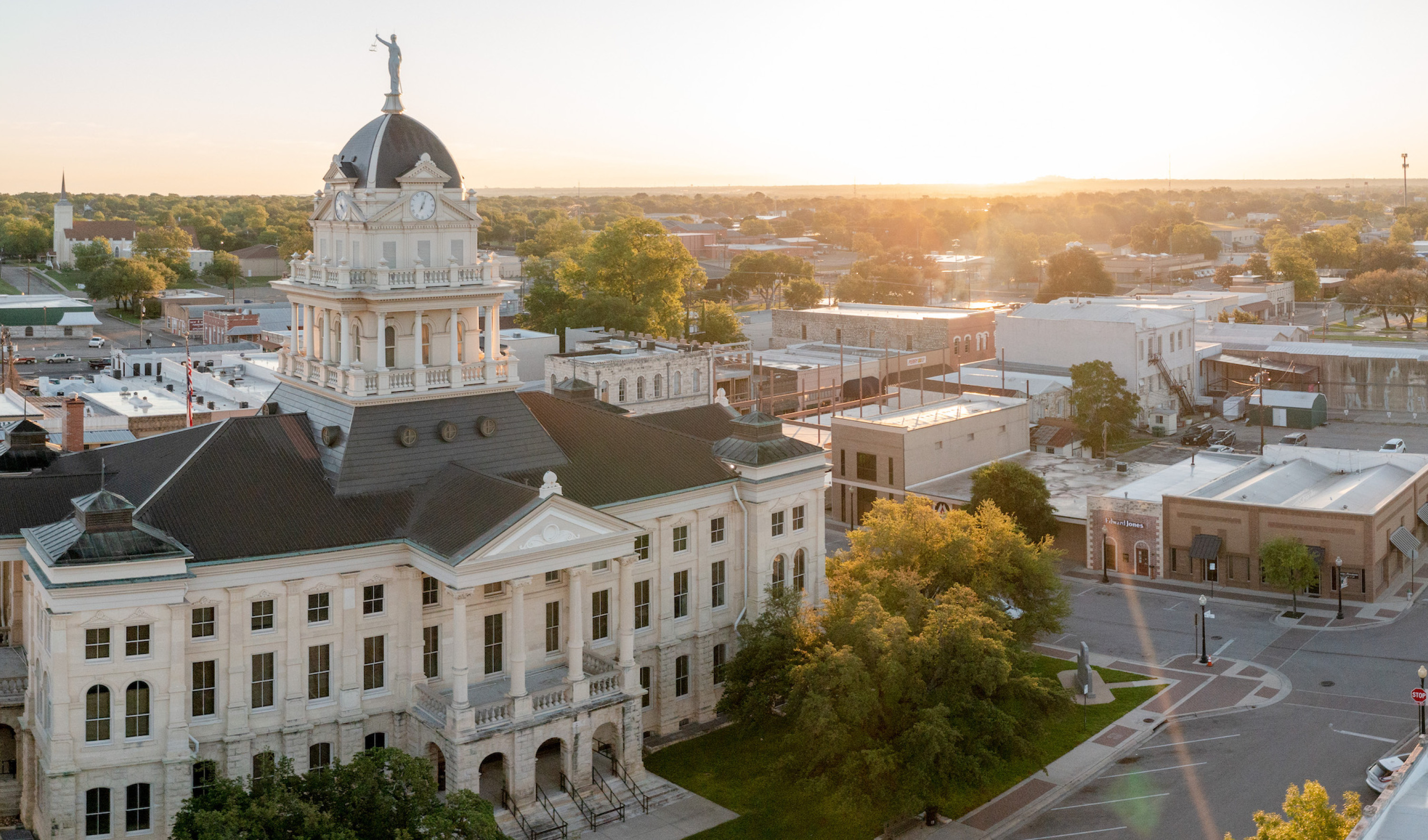Aerial view of courthouse with the sun rising in the background