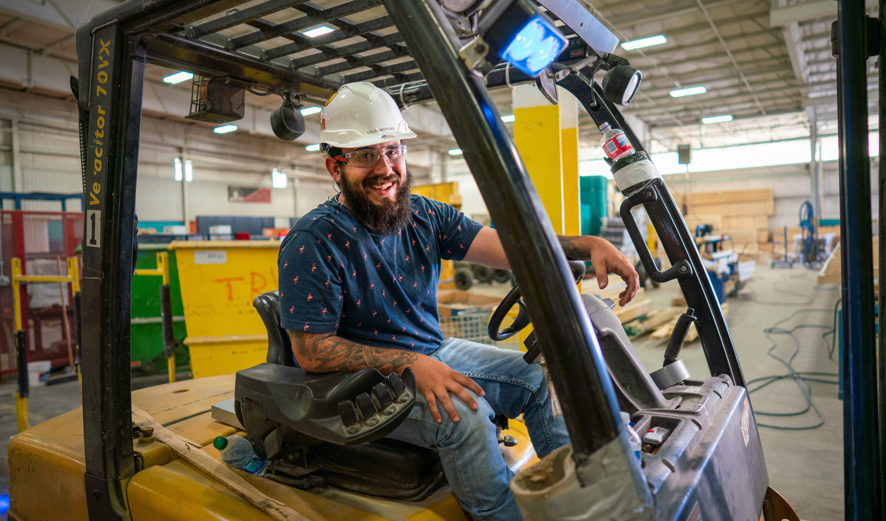Employee smiling on his forklift machine